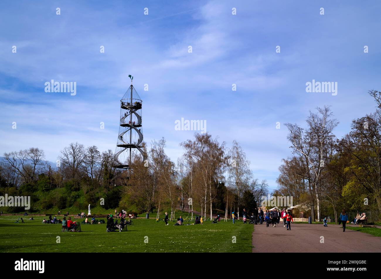 People relaxing in the park, observation tower and park landscape ...