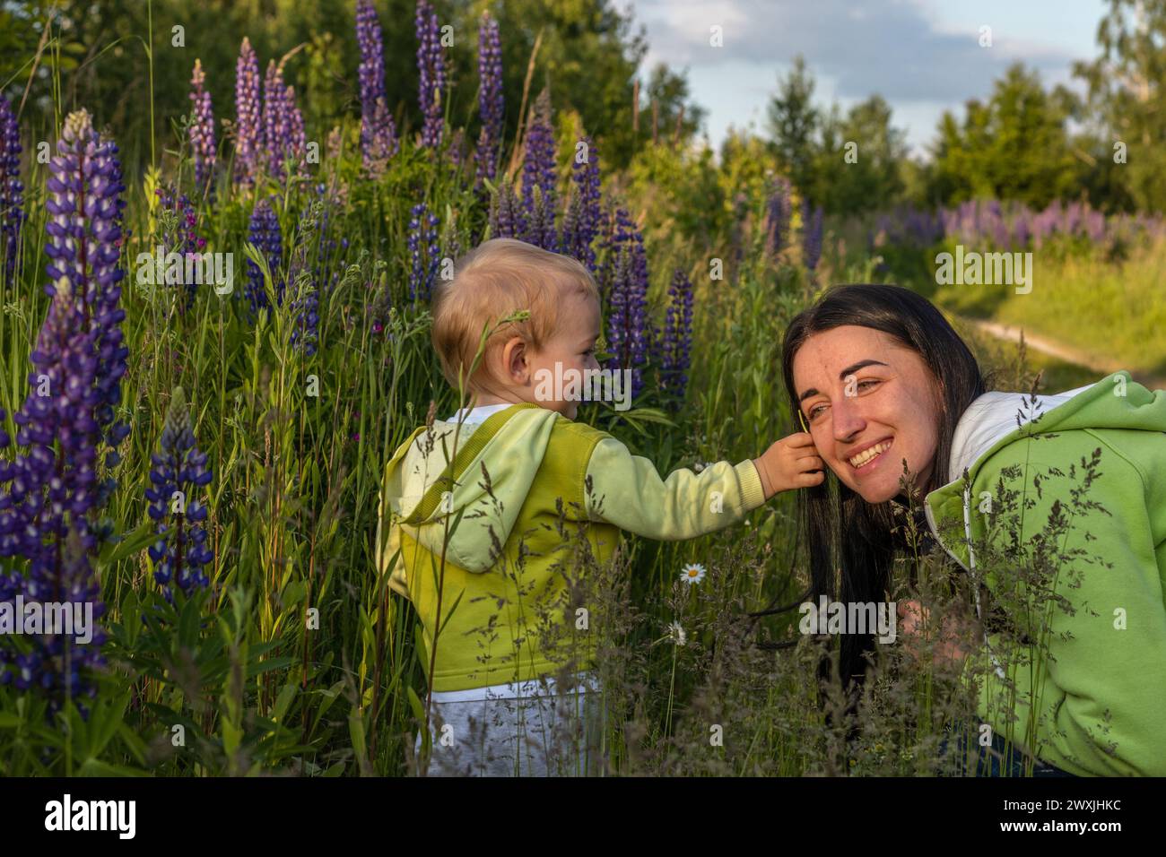 mother and child son are walking in a field of flowers Stock Photo - Alamy