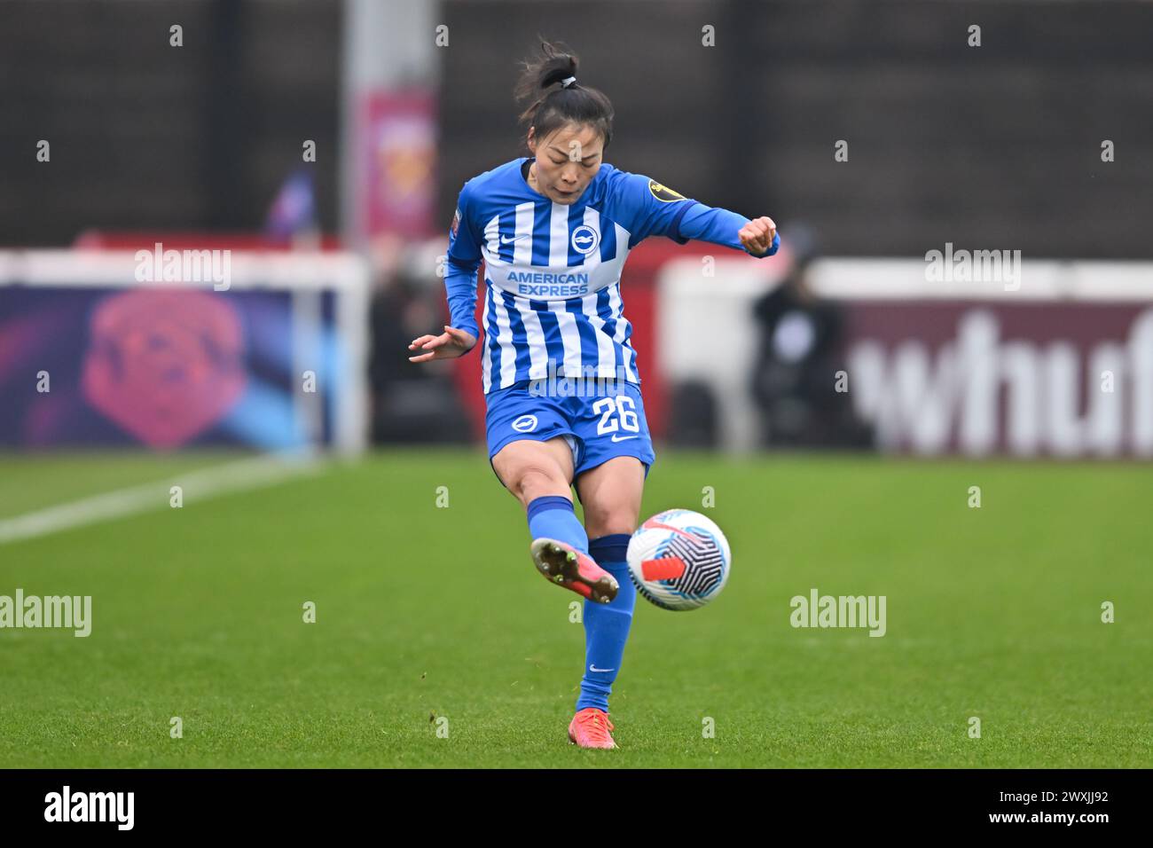Dagenham, Kent, UK. Sunday 31st March 2024.Mengwen Li (26 Brighton) Passes the ball during the Barclays FA Women's Super League match between West Ham United and Brighton and Hove Albion at the Chigwell Construction Stadium, Dagenham on Sunday 31st March 2024. (Photo: Kevin Hodgson | MI News) Credit: MI News & Sport /Alamy Live News Stock Photo