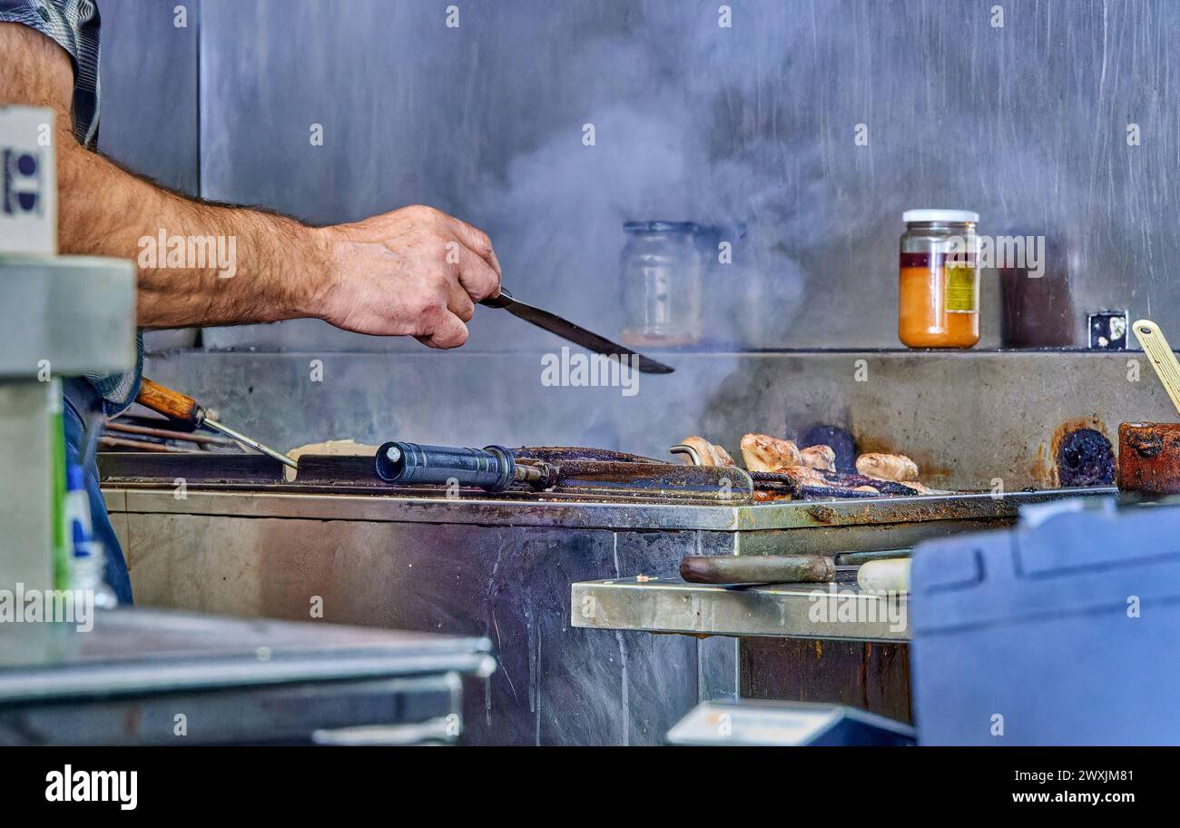 Professional Chef Grilling Steaks in an Industrial Kitchen Stock Photo