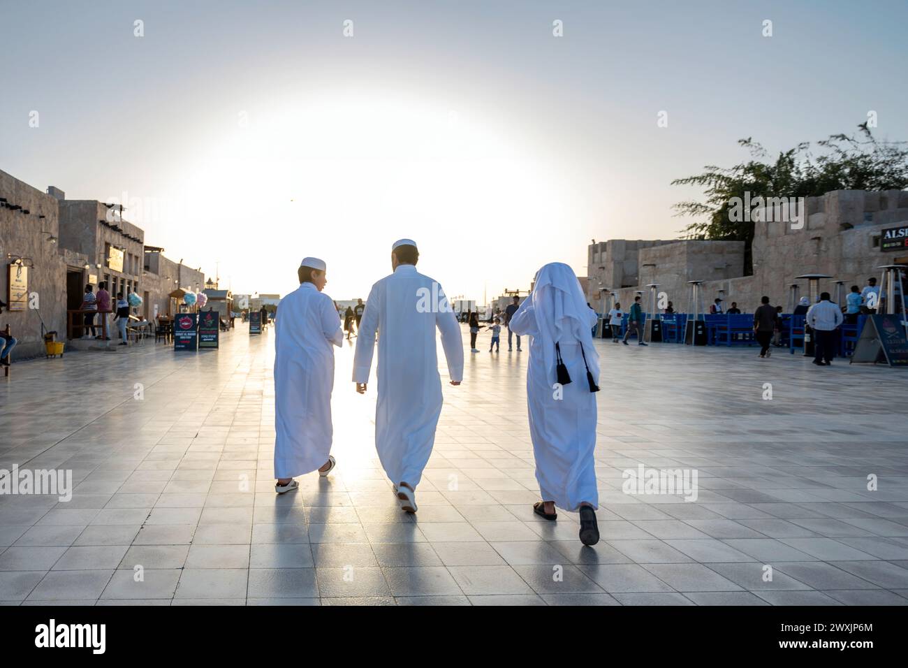 Happy Arabic kids wearing traditional Arabian gulf clothes in wakra Souq Doha Qatar. Stock Photo