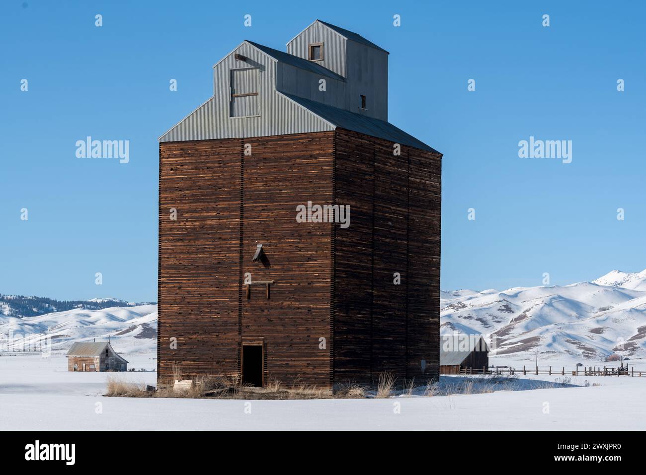Grain elevator, barn and abandoned school in Corral, Idaho. Stock Photo