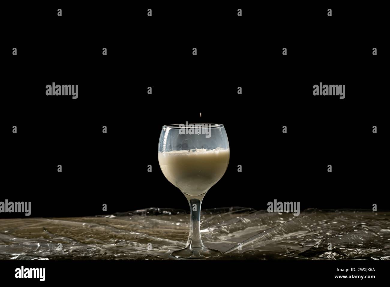 A glass of wine with milk inside. Isolated on black background Stock ...