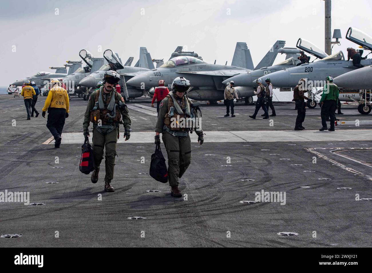 SOUTH CHINA SEA (March 28, 2024) U.S. Navy Lt. Clay Elward (left), and Lt. Amelia Verges, assigned to the “Black Knights” of Strike Fighter Squadron (VFA) 154, participate in flight operations aboard the Nimitz-class aircraft carrier USS Theodore Roosevelt (CVN 71), March 28, 2024. Theodore Roosevelt, flagship of Carrier Strike Group Nine, is underway conducting routine operations in the U.S. 7th Fleet area of operations. U.S. 7th Fleet is the U.S. Navy’s largest forward-deployed numbered fleet, and routinely interacts and operates with allies and partners in preserving a free and open Indo-Pa Stock Photo