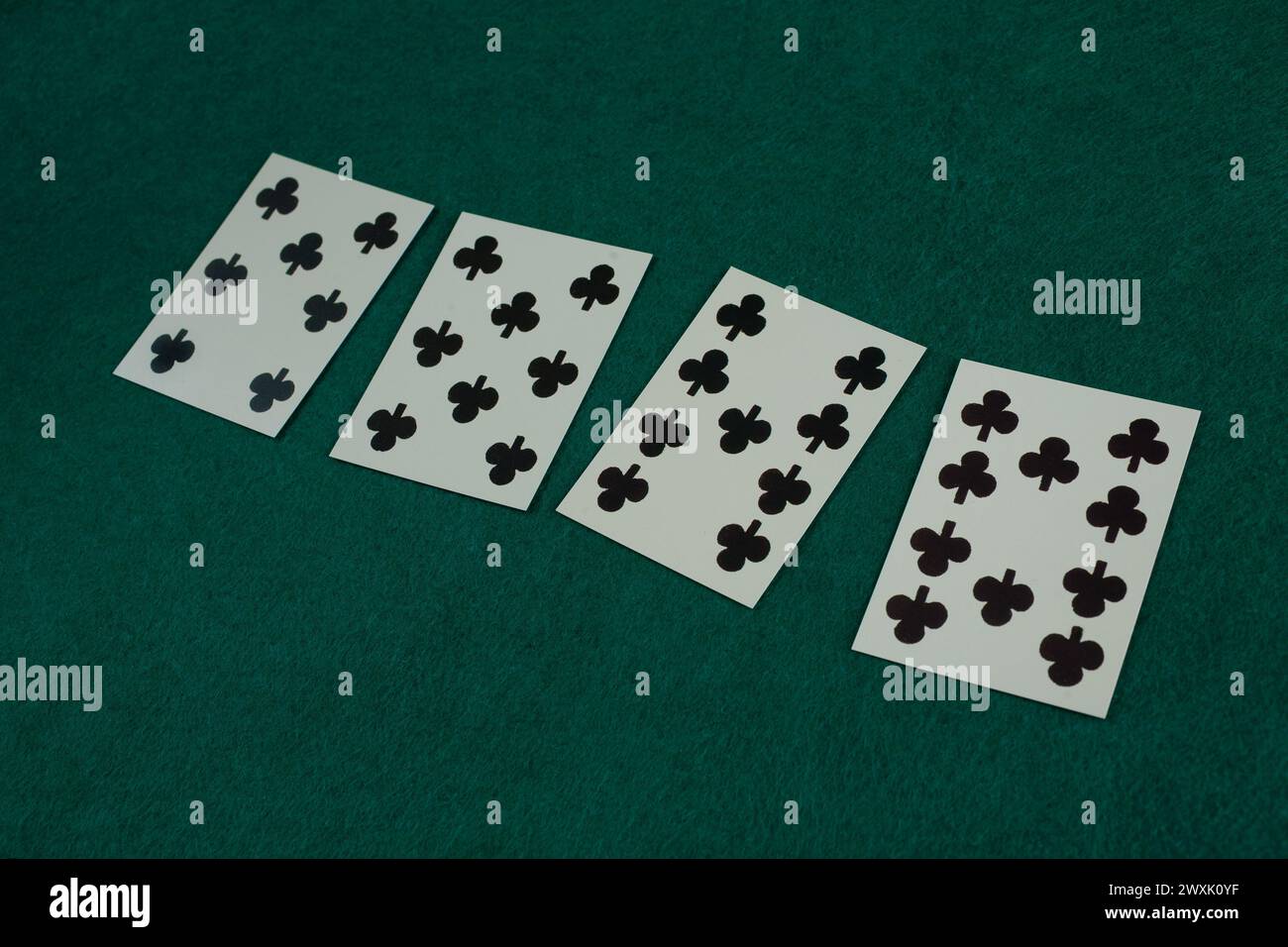 Old west era playing card on green gambling table. 7, 8, 9, 10 of spades. Stock Photo