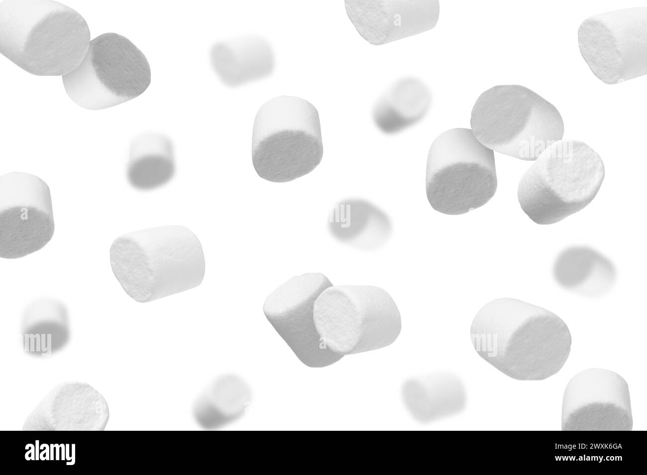 Many yummy marshmallows flying on white background Stock Photo - Alamy