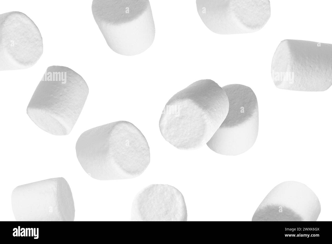 Many yummy marshmallows flying on white background Stock Photo - Alamy