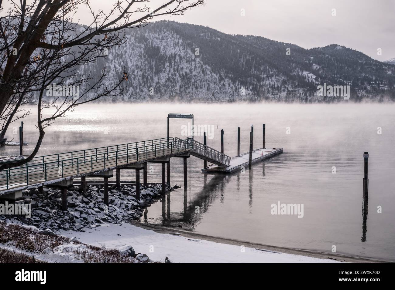 Mist rises from Lake Chelan around the Manson Pier and Jetty during a winter cold snap Stock Photo