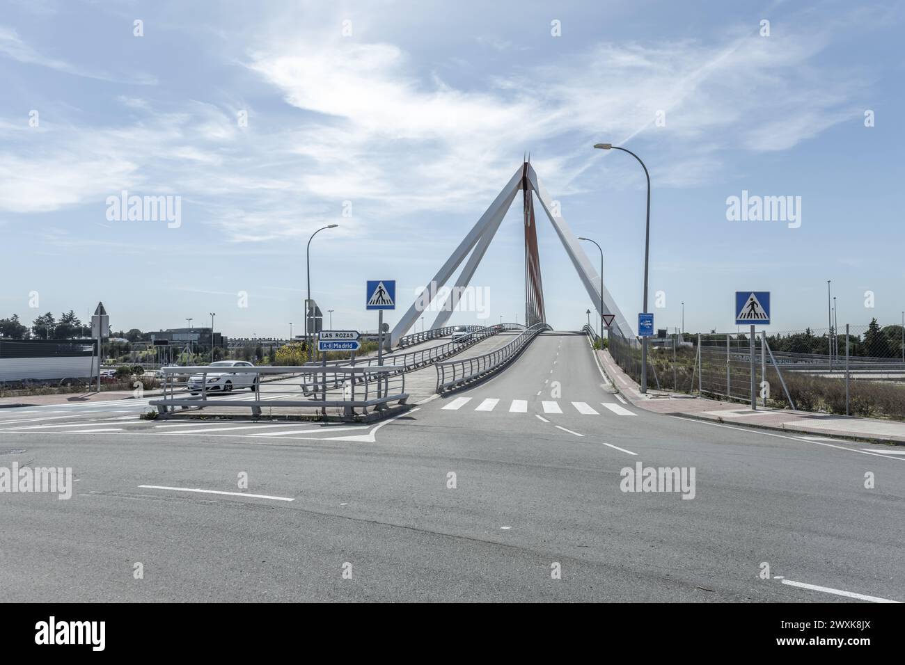 Image of the metal structure of a small bridge for road traffic and pedestrians, with indicative road traffic signage on a day with a bright sky Stock Photo