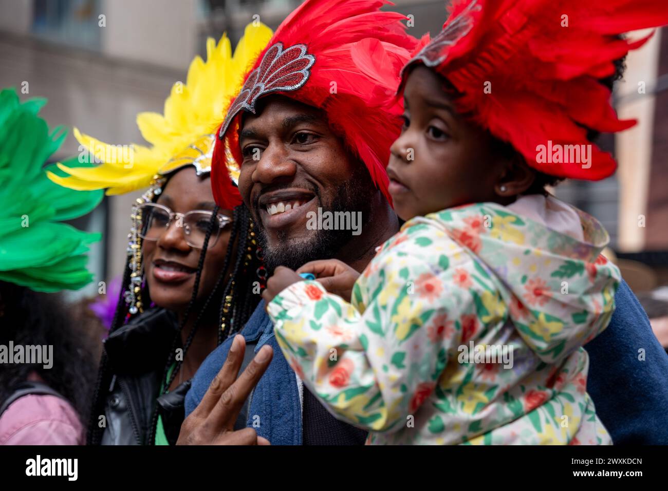 New York City, United States. 31st Mar, 2024. A family wearing feathered head bands. New York's Easter Parade and Bonnet Festival dates back to the 1870s. An Anual event, New Yorkers don colorful and creative Easter outfits to show off in front of St Patrick's Cathedral on Fifth Avenue. (Photo by Syndi PIilar/SOPA Images/Sipa USA) Credit: Sipa USA/Alamy Live News Stock Photo