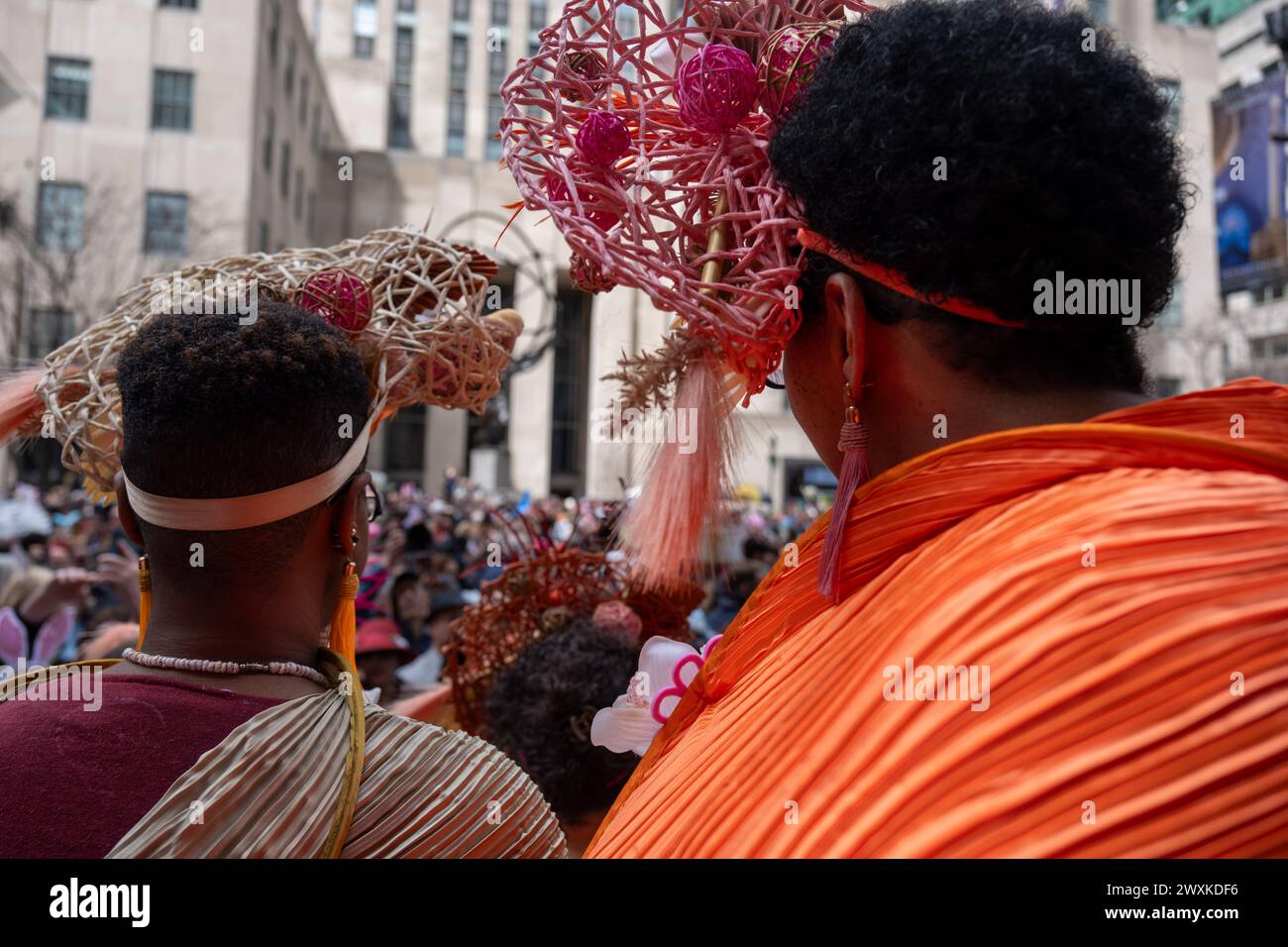 New York City, United States. 31st Mar, 2024. Two women shot from behind wear colorful head bands. New York's Easter Parade and Bonnet Festival dates back to the 1870s. An Anual event, New Yorkers don colorful and creative Easter outfits to show off in front of St Patrick's Cathedral on Fifth Avenue. (Photo by Syndi PIilar/SOPA Images/Sipa USA) Credit: Sipa USA/Alamy Live News Stock Photo