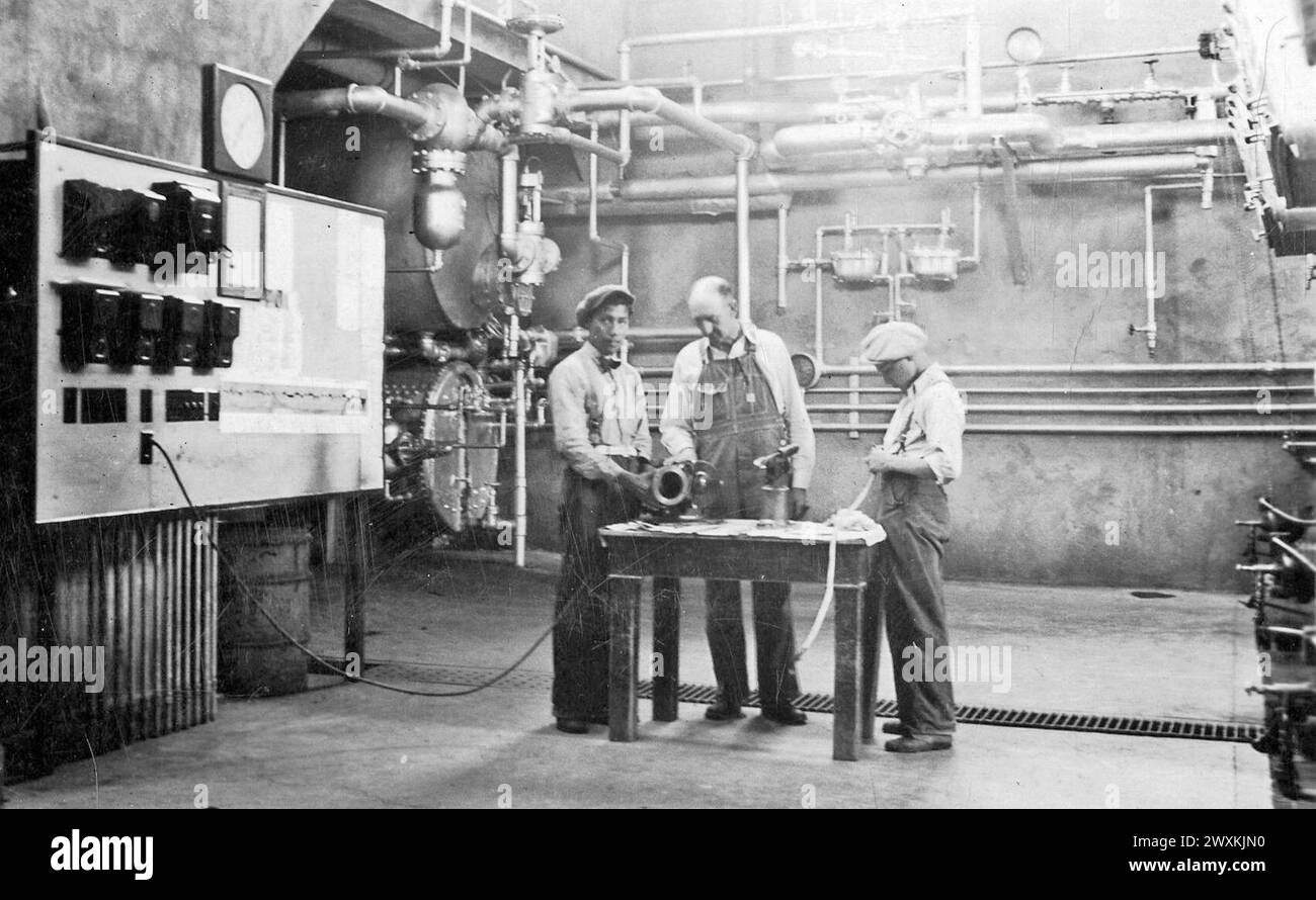 Three men in an engineering classroom of a school in South Dakota ca. 1935 Stock Photo