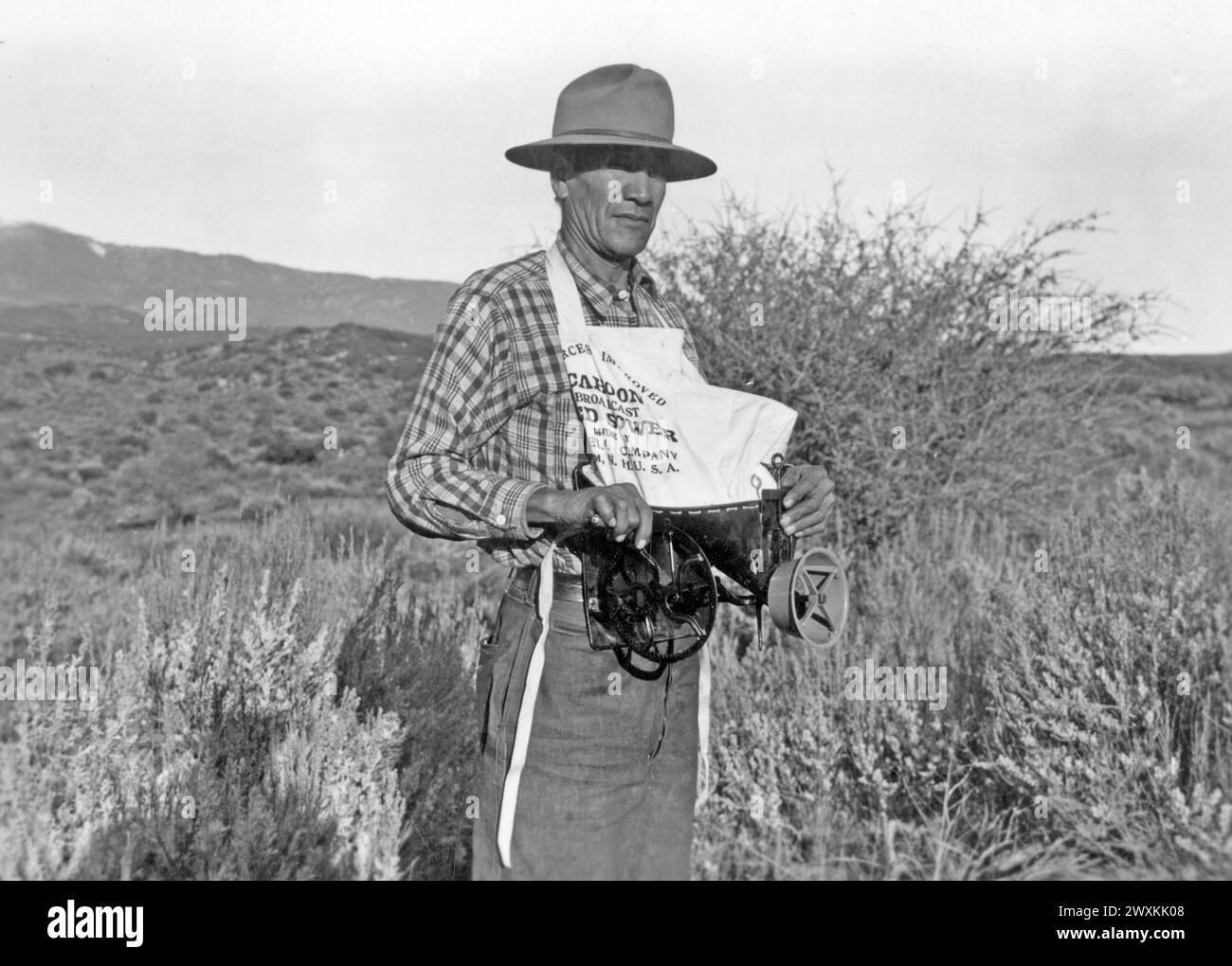 Photograph of a Man with a Cahoon Seed Sower in rural California ca