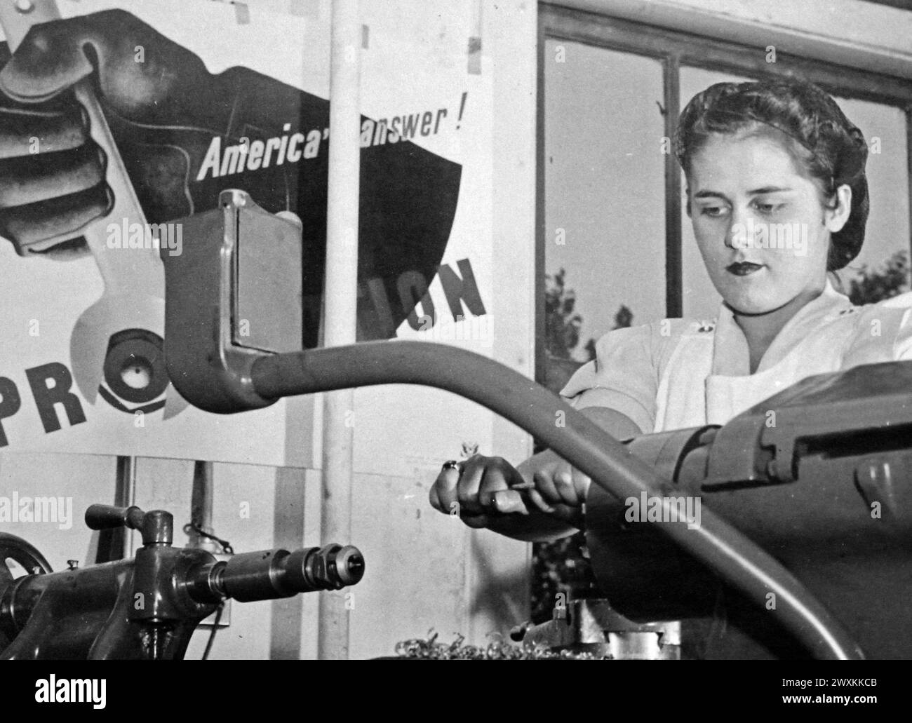 This photograph depicts a young woman affiliated with the National Youth Administration as she works in a machine shop in Connecticut ca. 1939-1943 Stock Photo