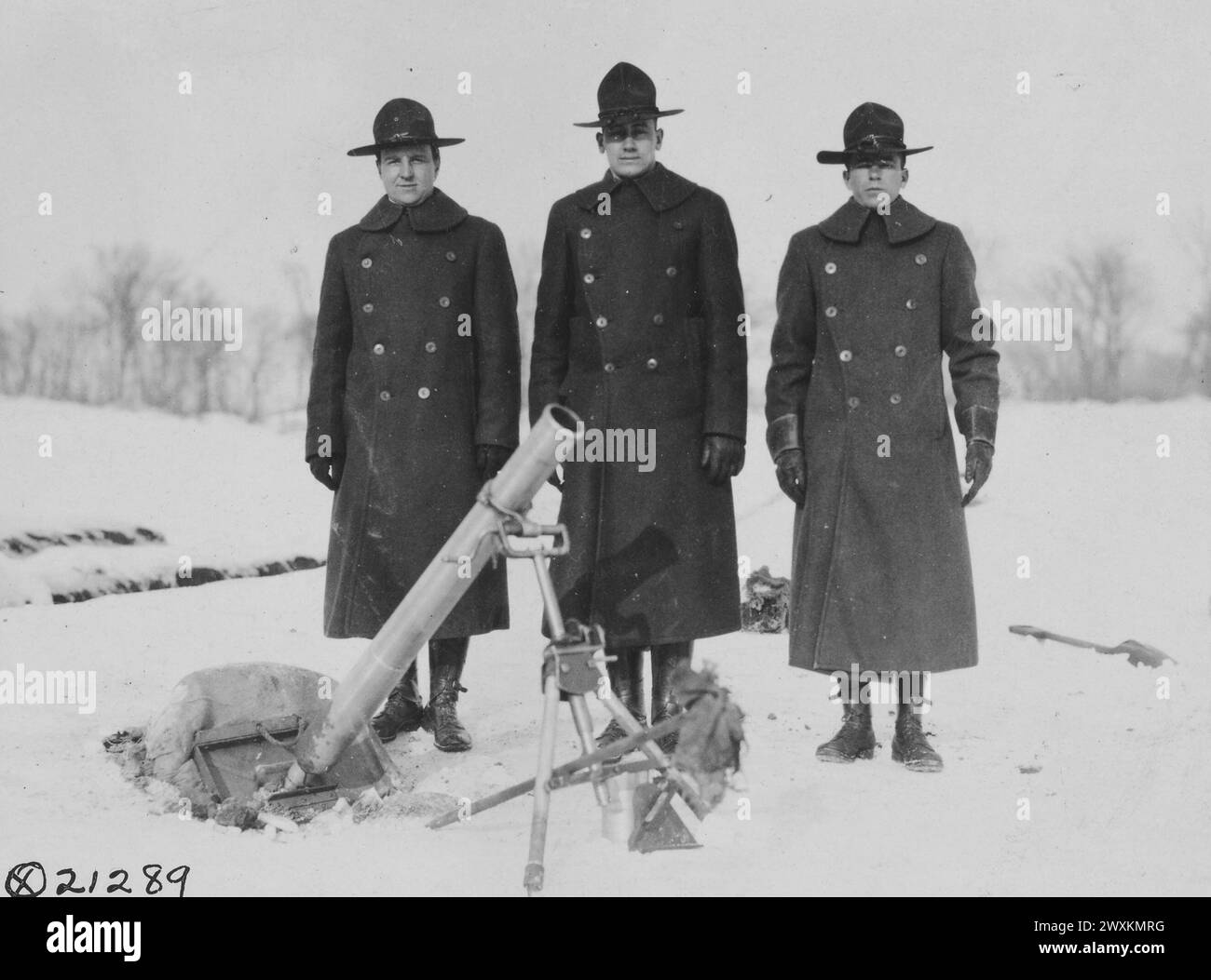 Soldiers at Camp Sherman in Chillocothe, OH standing in the snow behind a type of trench mortar ca. 1918 Stock Photo