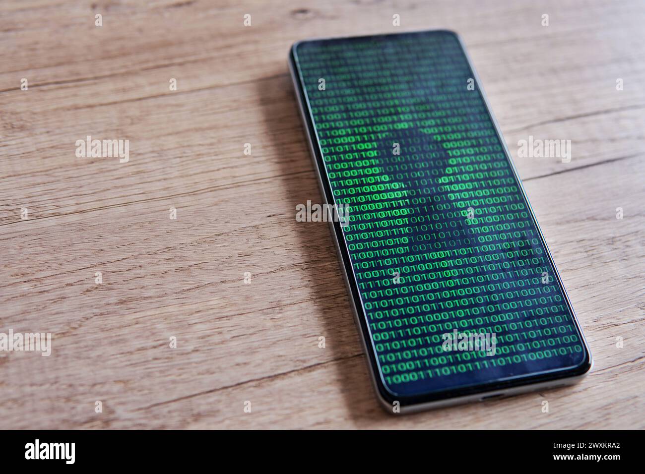 Smartphone with glowing binary code and keyhole on the screen. Copy space for text. Cyber security concept. Stock Photo
