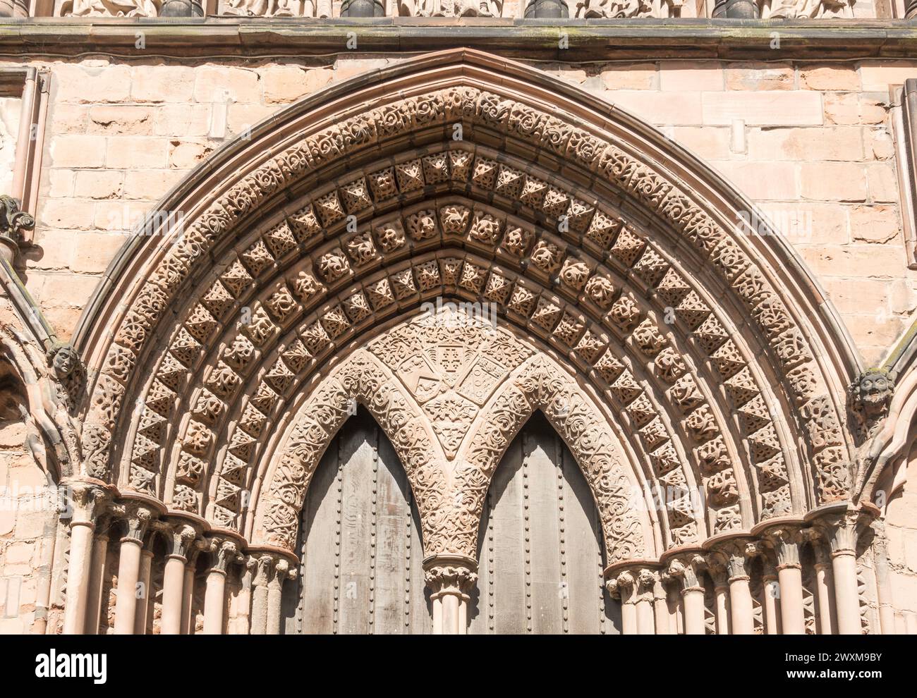 Decorated arch over the south door of Lichfield cathedral, in Staffordshire, England, UK Stock Photo