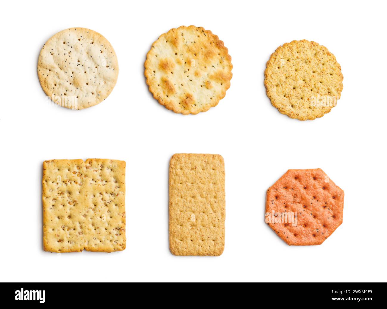A selection of various crackers neatly placed in a straight line on the white background. Stock Photo
