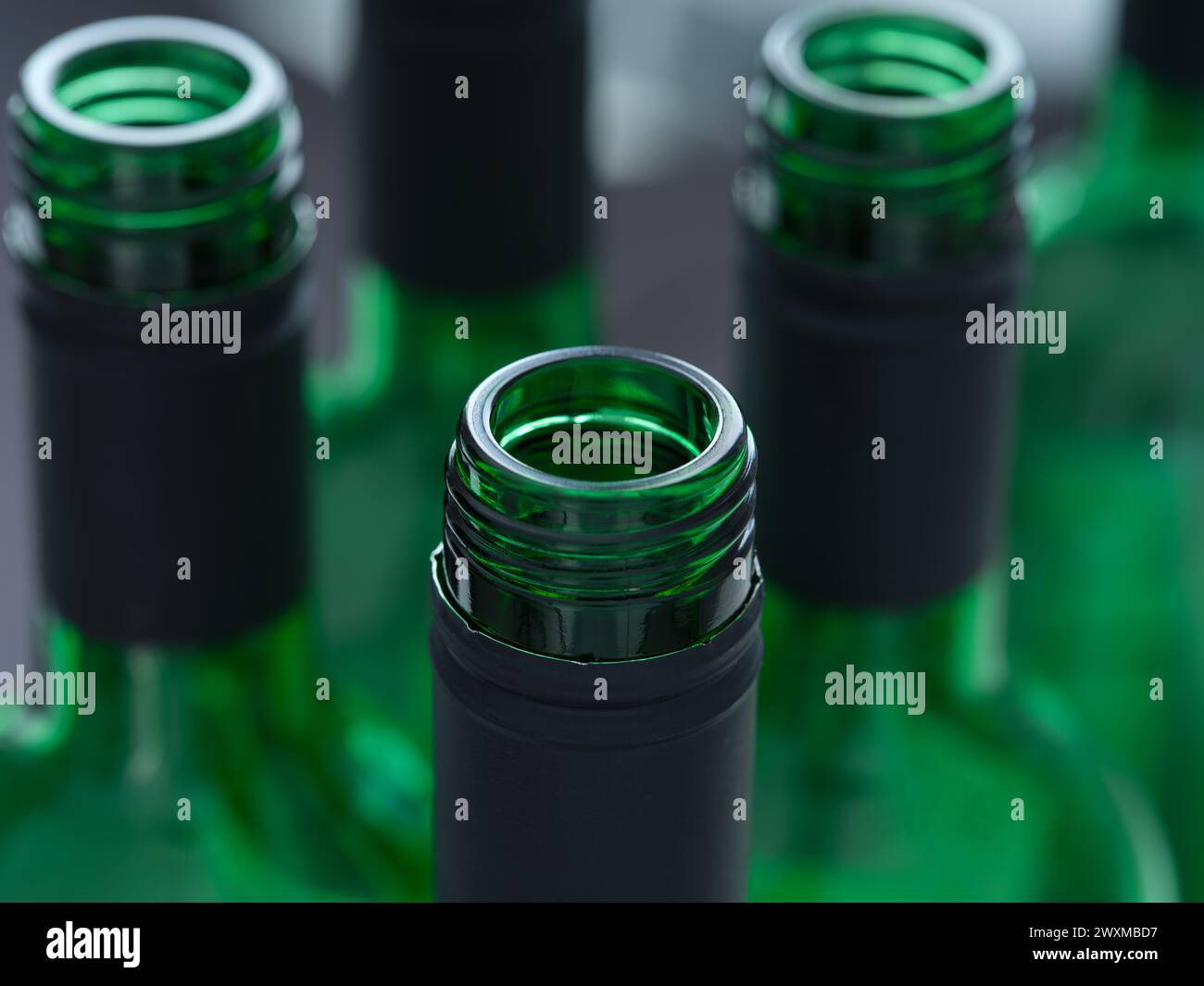 A close-up shot of the tops of open wine bottles Stock Photo