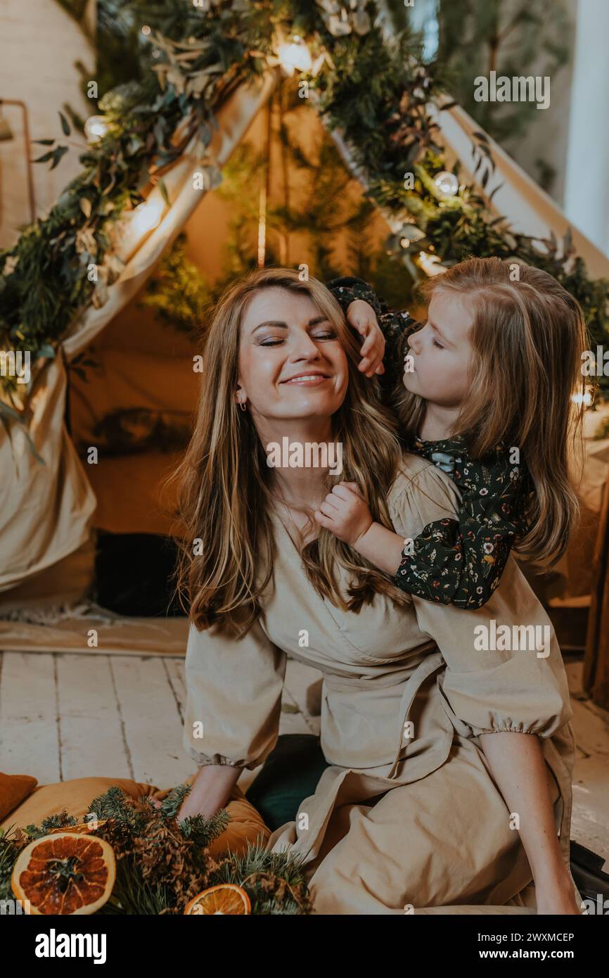 A girl stroking her mothers hair Stock Photo