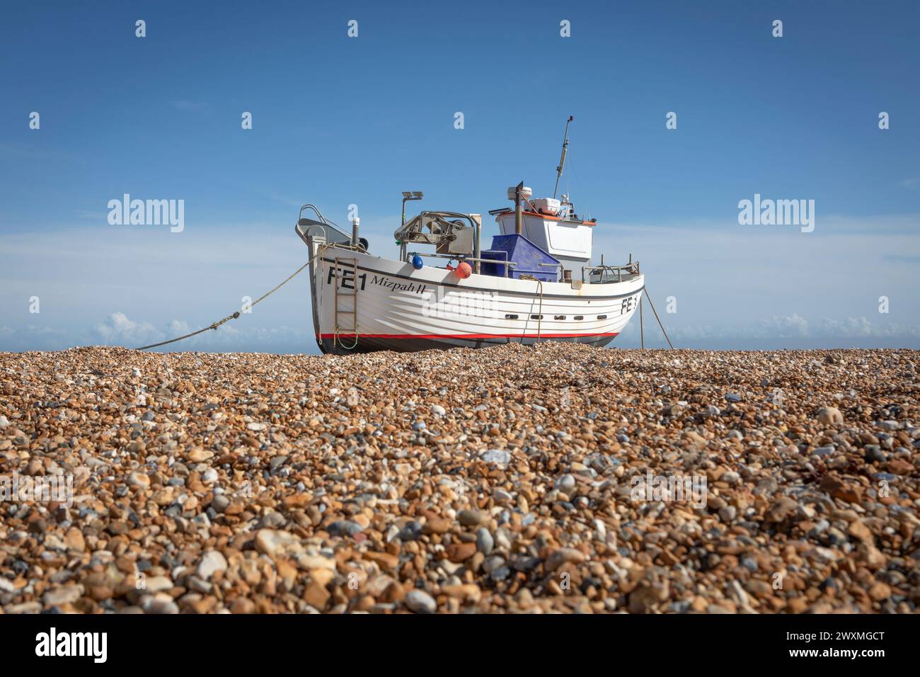 A fishing boat on the shingle of Fisherman's Beach, Hythe, Kent Stock