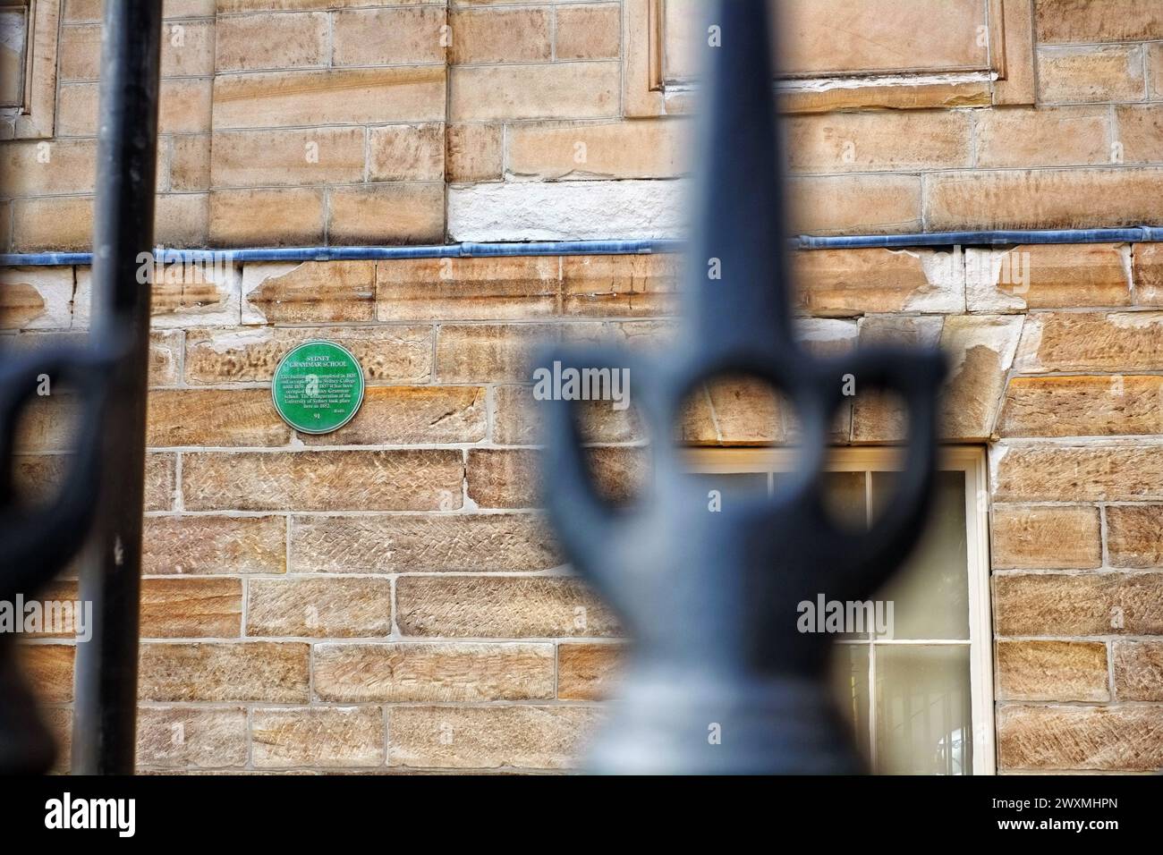 Sydney Grammar School, round green history plaque mounted on a