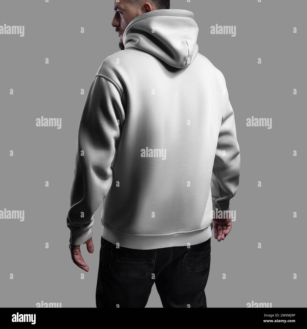 White oversized hoodie template on a bearded man, back view. Streetwear with hood, cuffs, isolated on background with shadows. Mockup of textured wide Stock Photo