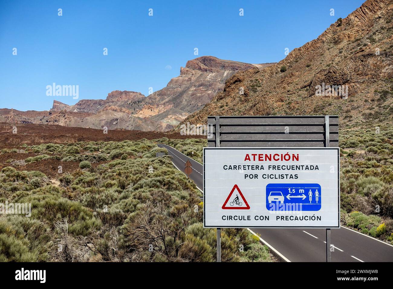 Cyclist warning road sign in Spanish with Tenerife mountain landscape in the background under clear blue sky Stock Photo