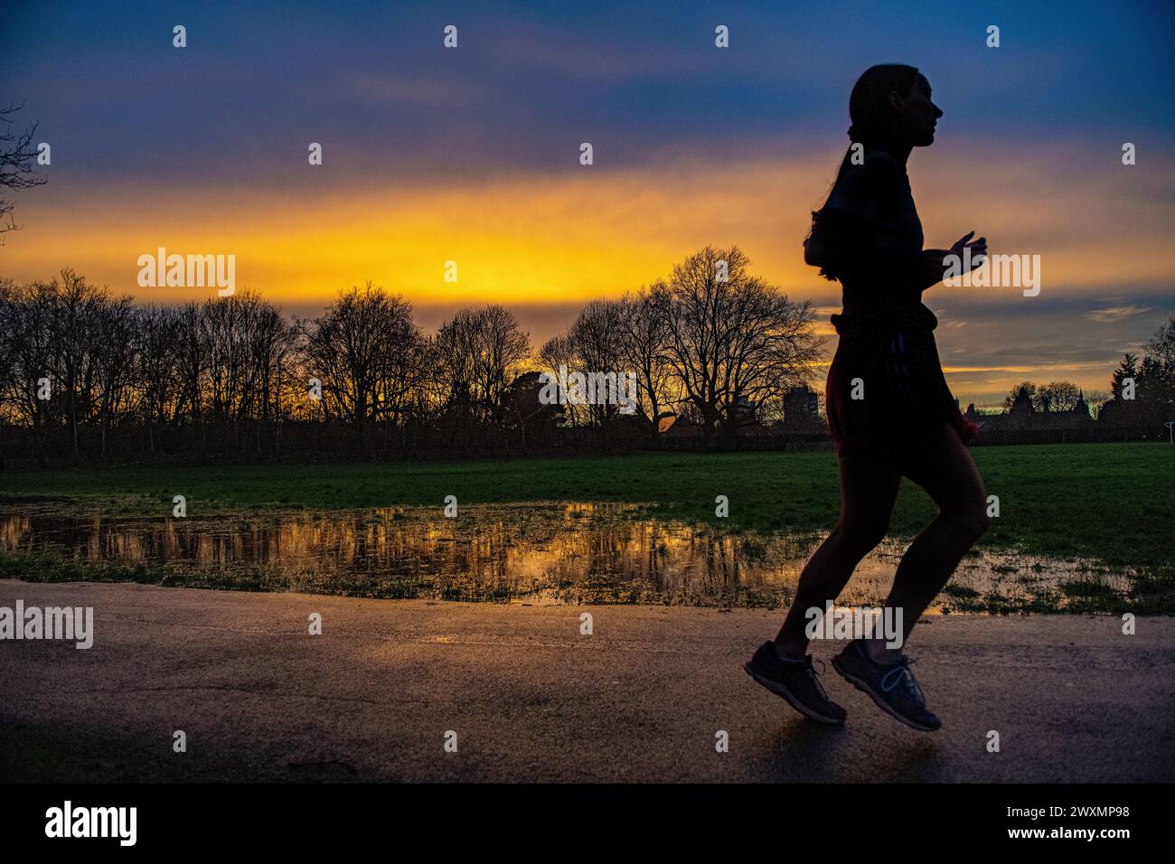 Jogging at sunset in a London park Stock Photo