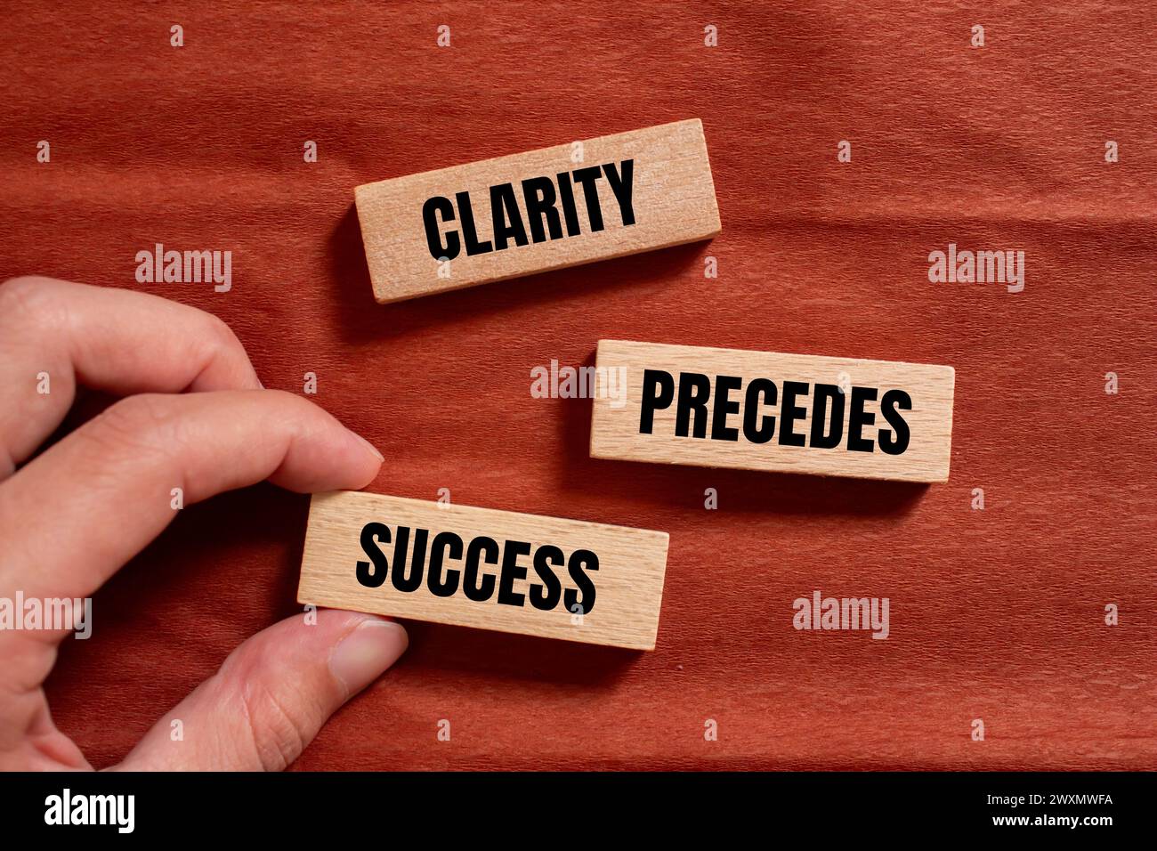 Clarity precedes success words written on wooden blocks with brown ...