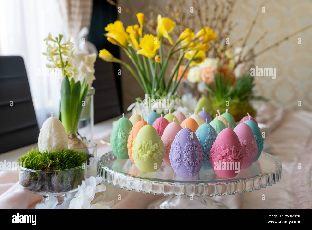 Colorful easter egg soy wax candles. Spring background Stock Photo