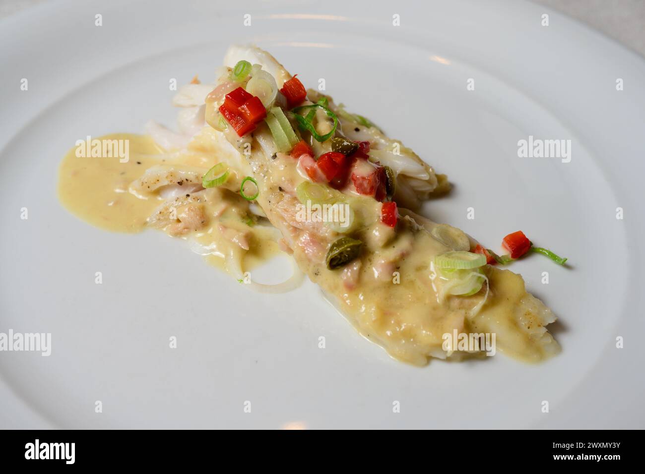 Skate Wing or Ray Wing Prepared with Tuna Mayonnaise Sauce and Red Bell Pepper Stock Photo