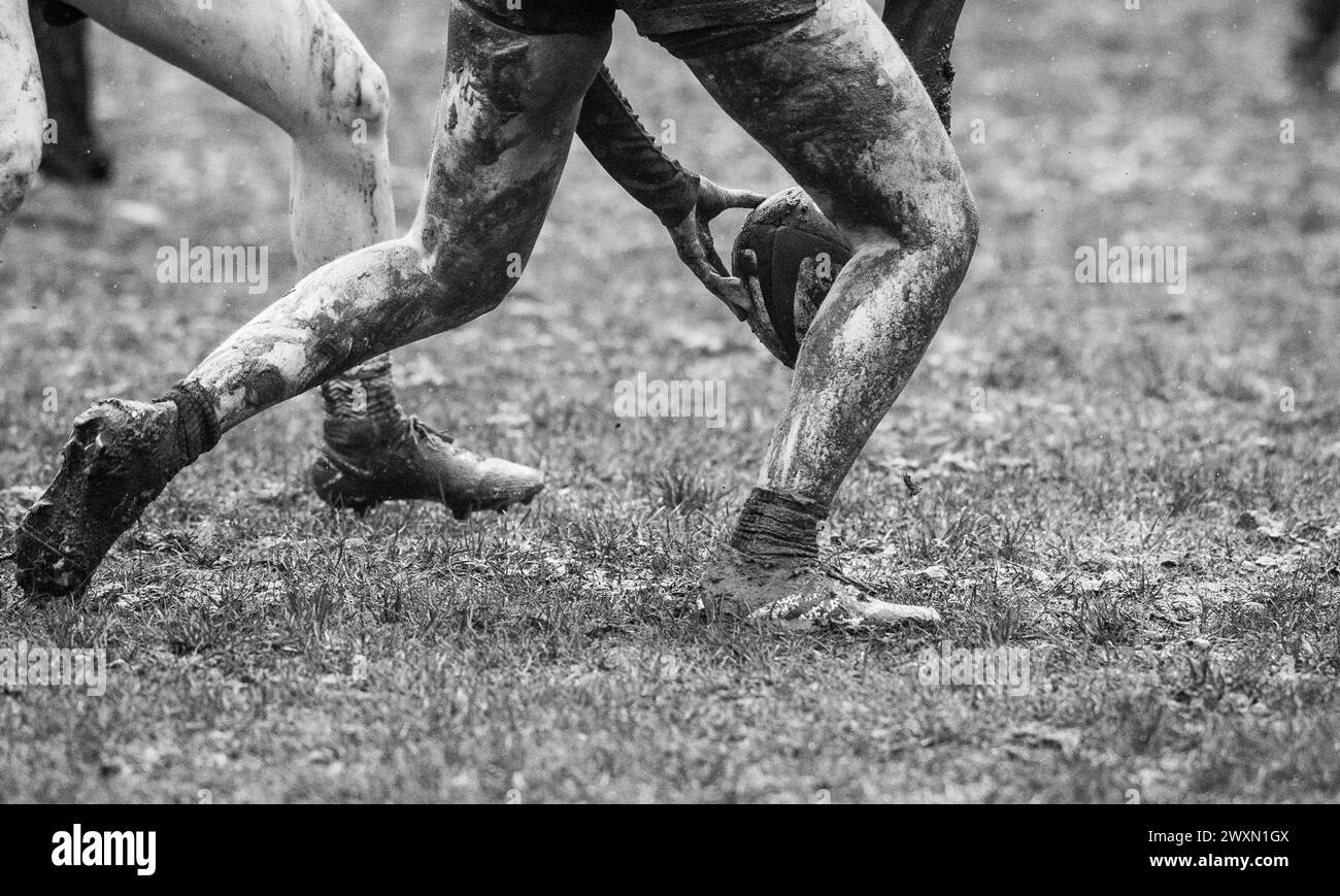 English amateur rugby union women's game playing in wet and muddy conditions. Stock Photo