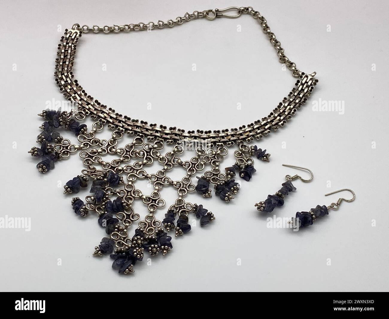 A silver necklace paired with black beaded earrings and necklace Stock Photo