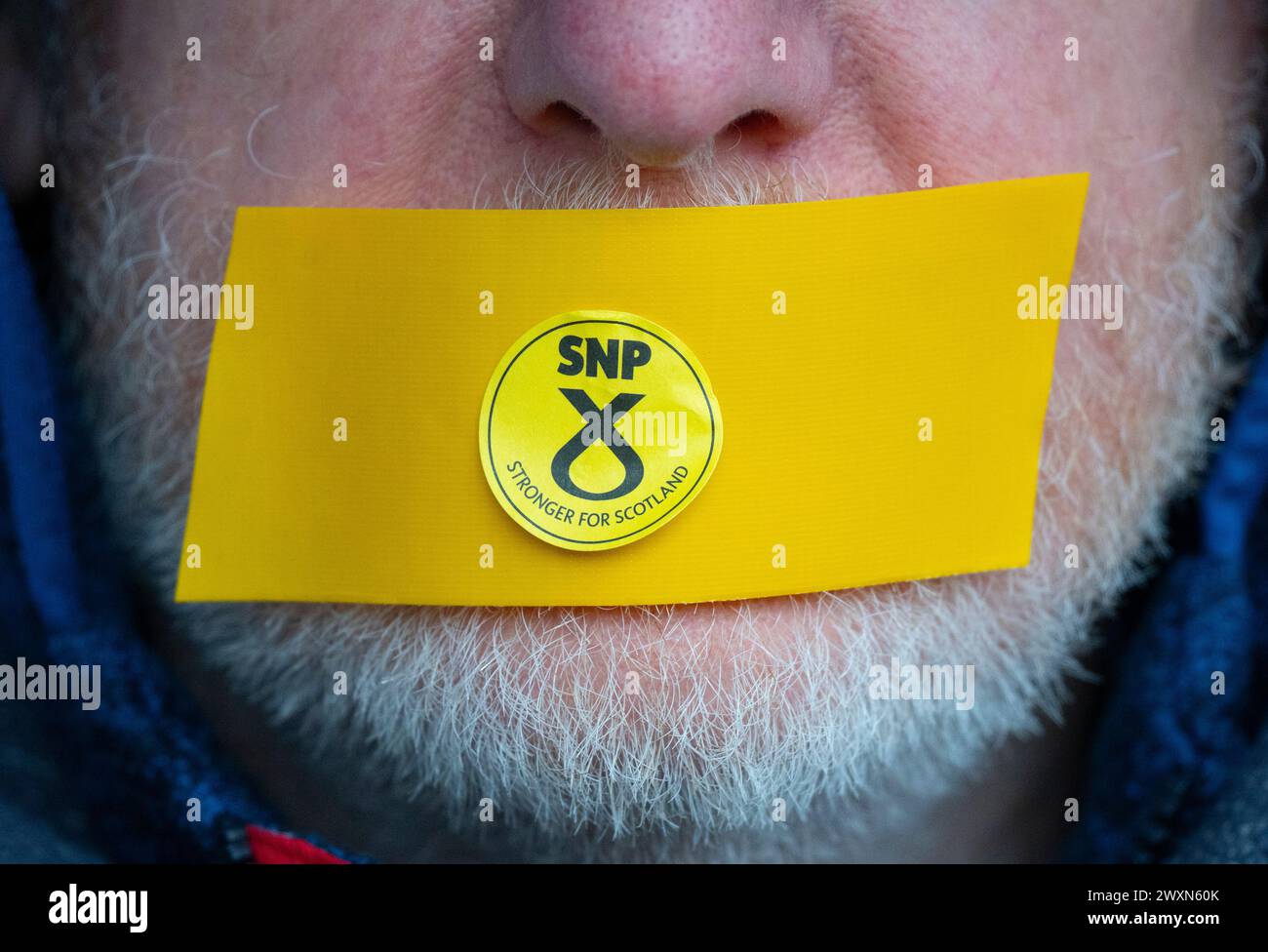 Edinburgh,, Scotland, UK. 1st April, 2024. Various political and community groups gathered outside the Scottish Parliament today to protest against the introduction of The Hate Crime and Public Order (Scotland) Act also known as the hate crime bill which came into force on 1 April. Protesters cover their mouths with yellow tape to signify the SNP policy of censorship.  Iain Masterton/Alamy Live News Stock Photo