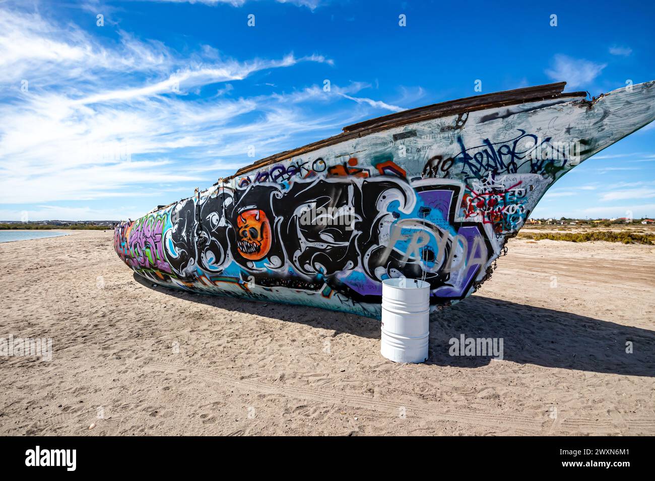 La Paz, Baja California Sur Mexico. February 9, 2023. Side front view of an old shipwreck painted with graffiti in sand of Mexican coastal beach El Ce Stock Photo
