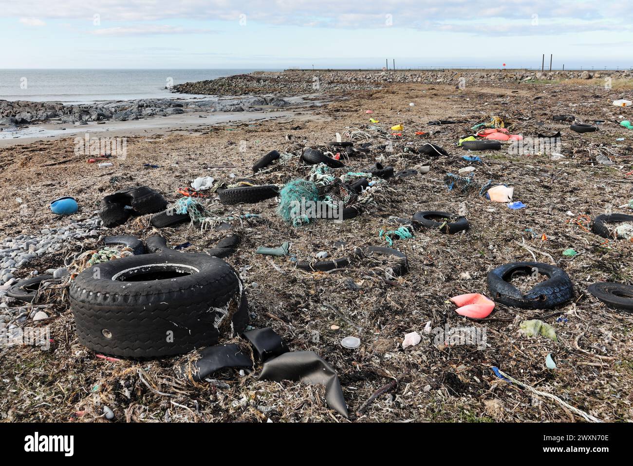 Plastics and other waste washed up on the coast near Fraserburgh, Aberdeenshire, Scotland, UK. A lot of this waste is produced by the fishing industry Stock Photo