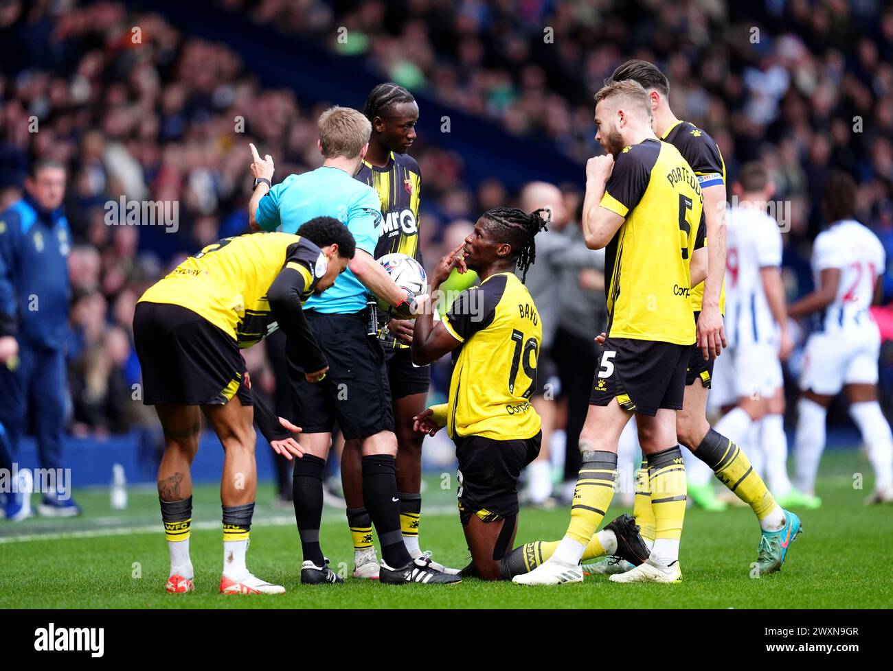 Watford's Vakoun Issouf Bayo (centre) speaks to referee Gavin Ward during the Sky Bet Championship match at The Hawthorns, West Bromwich. Picture date: Monday April 1, 2024. Stock Photo