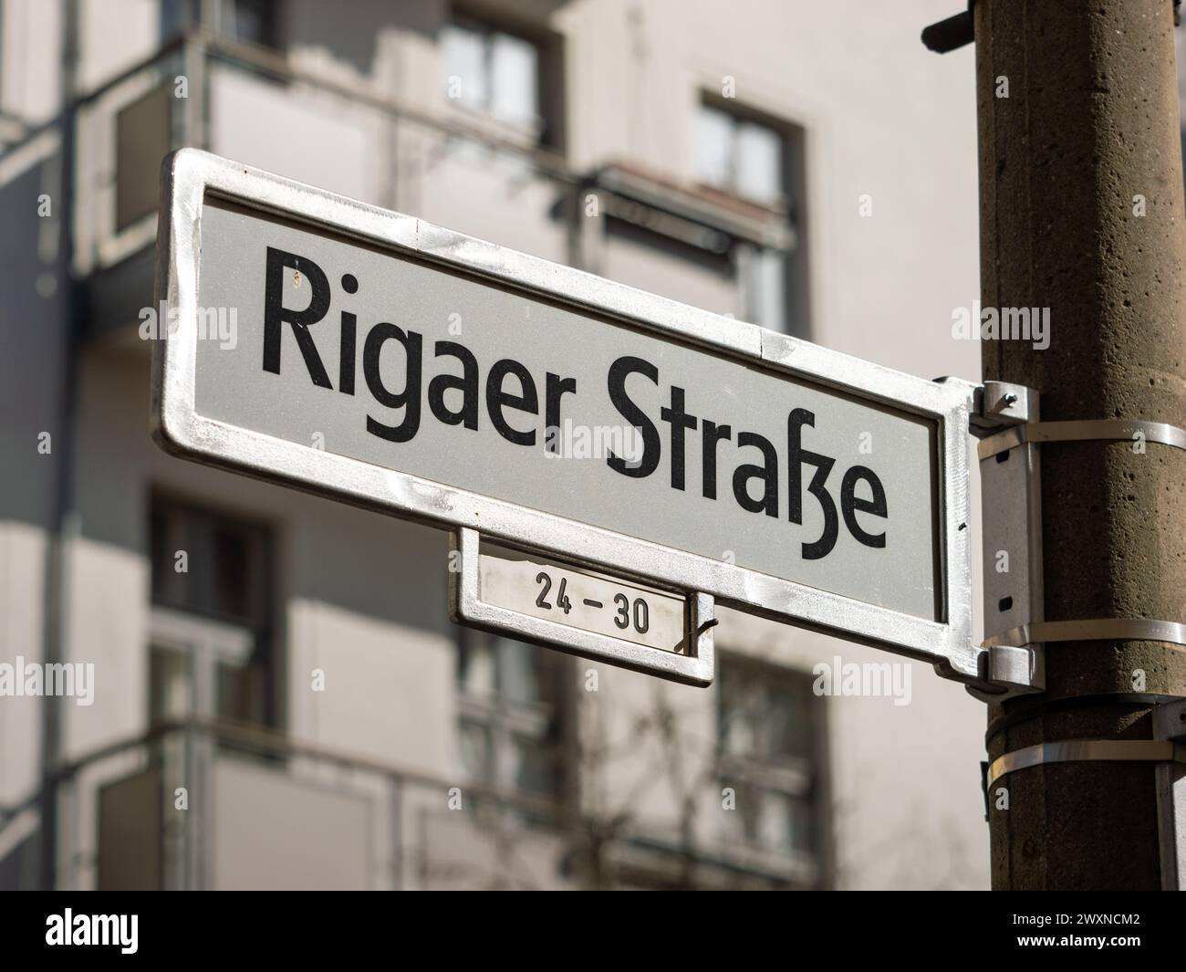 Rigaer Straße street sign in Berlin. Road name guide at an intersection. The location is in Friedrichshain and popular for house squatting. Stock Photo