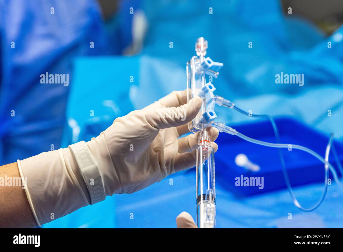 The procedure of inserting a double lumen catheter into a patient with cardiovascular occlusion in the hospital. Doctor insert double lumen catheter. Stock Photo