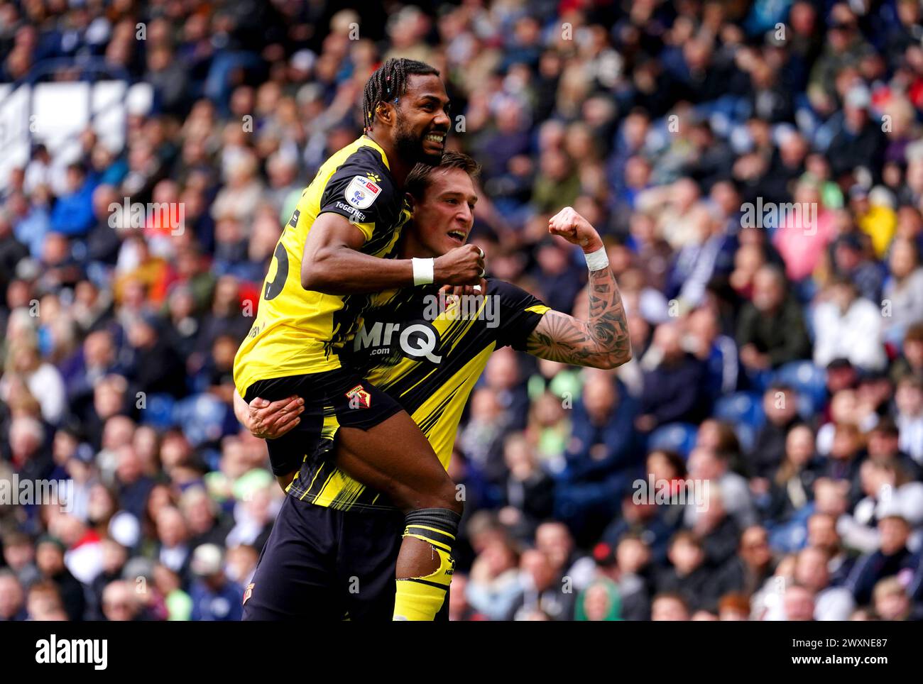 Watford's Mileta Rajovic (right) celebrates with team-mate Emmanuel Dennis after scoring their side's second goal of the game during the Sky Bet Championship match at The Hawthorns, West Bromwich. Picture date: Monday April 1, 2024. Stock Photo