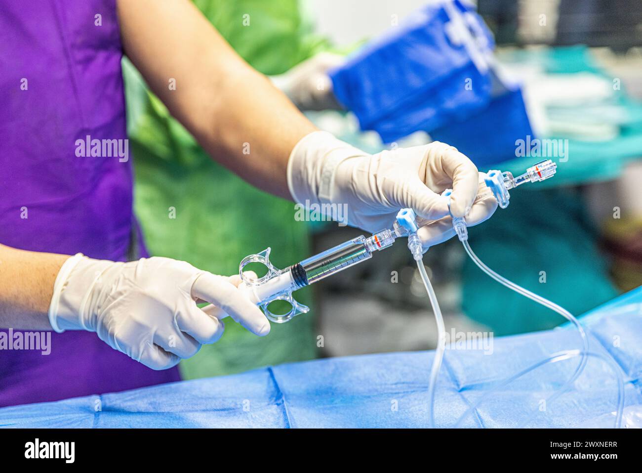 The procedure of inserting a double lumen catheter into a patient with cardiovascular occlusion in the hospital. Doctor insert double lumen catheter. Stock Photo