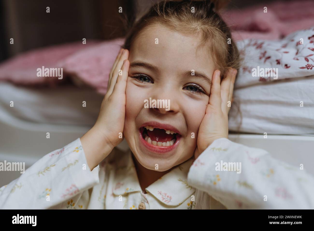 Portrait of cute girl smiling with gap-toothed grin, missing her baby teeth. Stock Photo