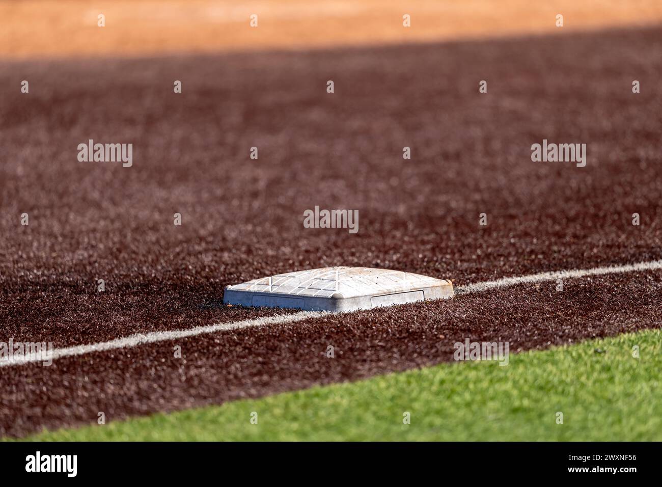 View of high school or college synthetic turf softball field third base. Stock Photo