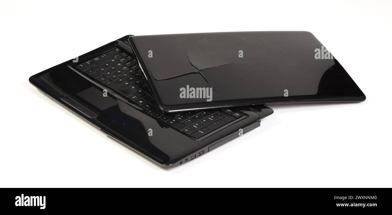 Partially Broken Computer Old broken laptop isolated on white a background Stock Photo - Alamy