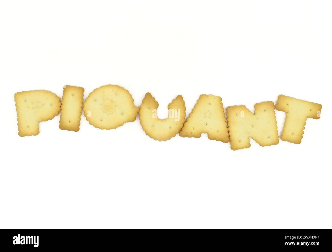Capital letter shaped biscuits forming word piquant isolated on white background Stock Photo