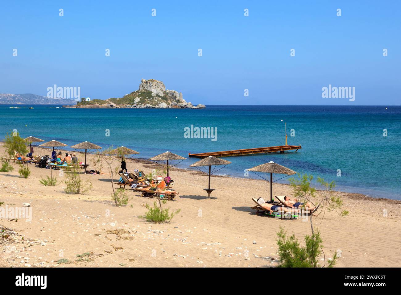 Kos, Greece - May 12, 2023: Tourists sunbathing Kefalos beach on the island of Kos. Greece Stock Photo