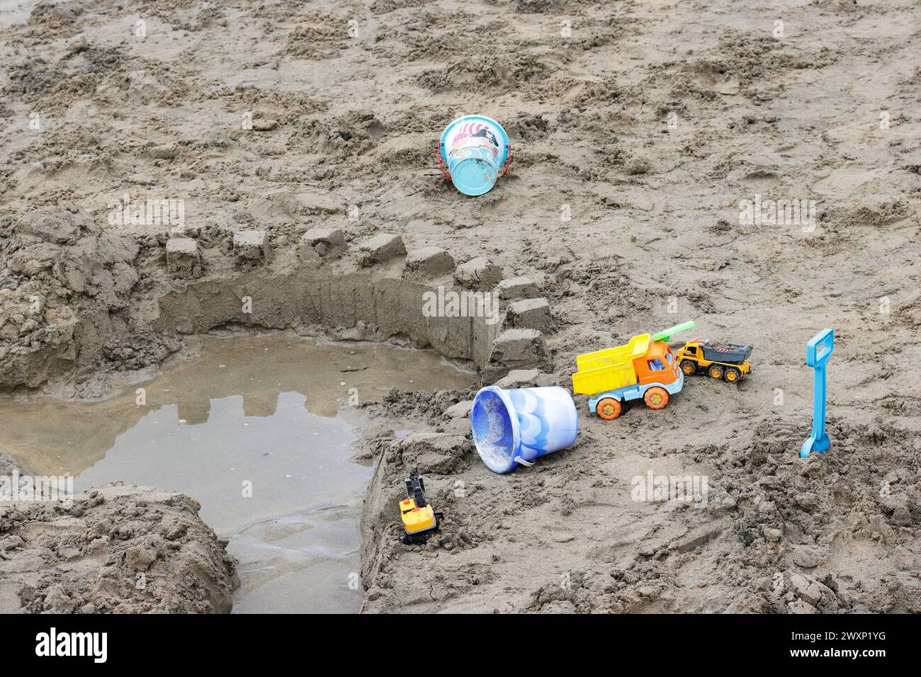 Abandoned toys around sand castle in Perranporth, north coast of Cornwall Stock Photo