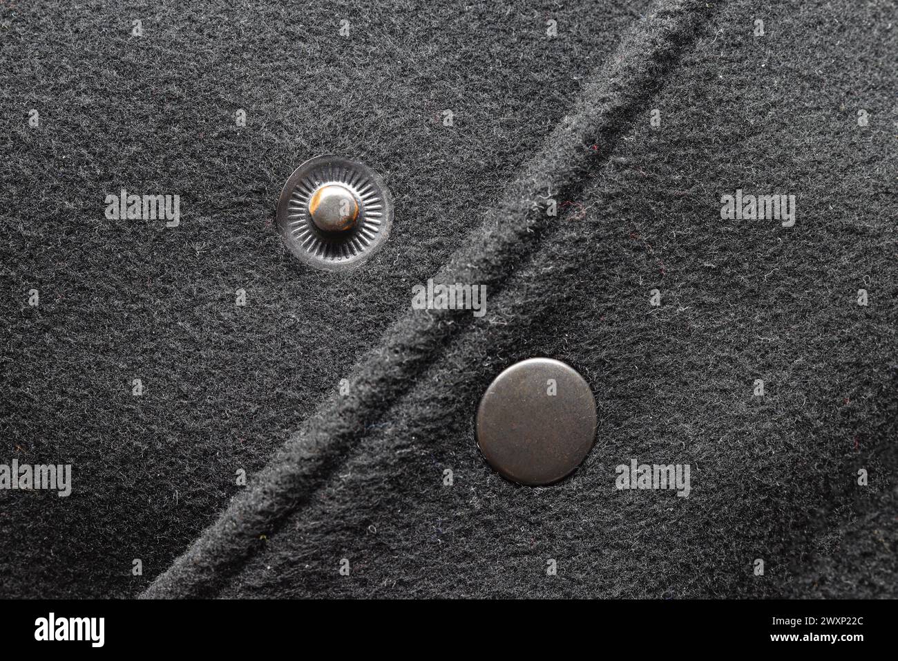 Mettallic clasp button on black jacket close-up Stock Photo