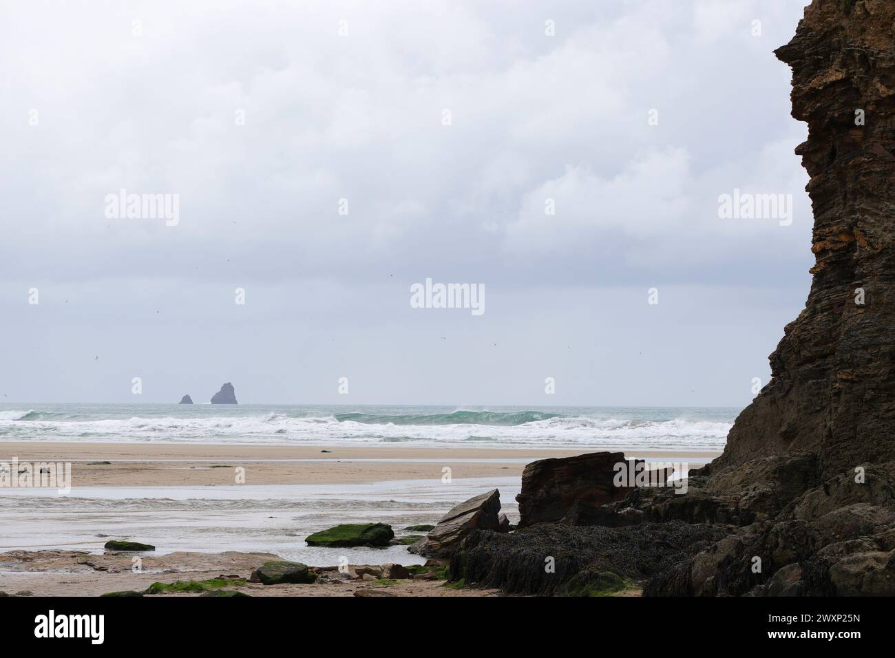 Views of dramatic cliffs at Perranporth, north coast of Cornwall, on a cloudy windy afternoon Stock Photo